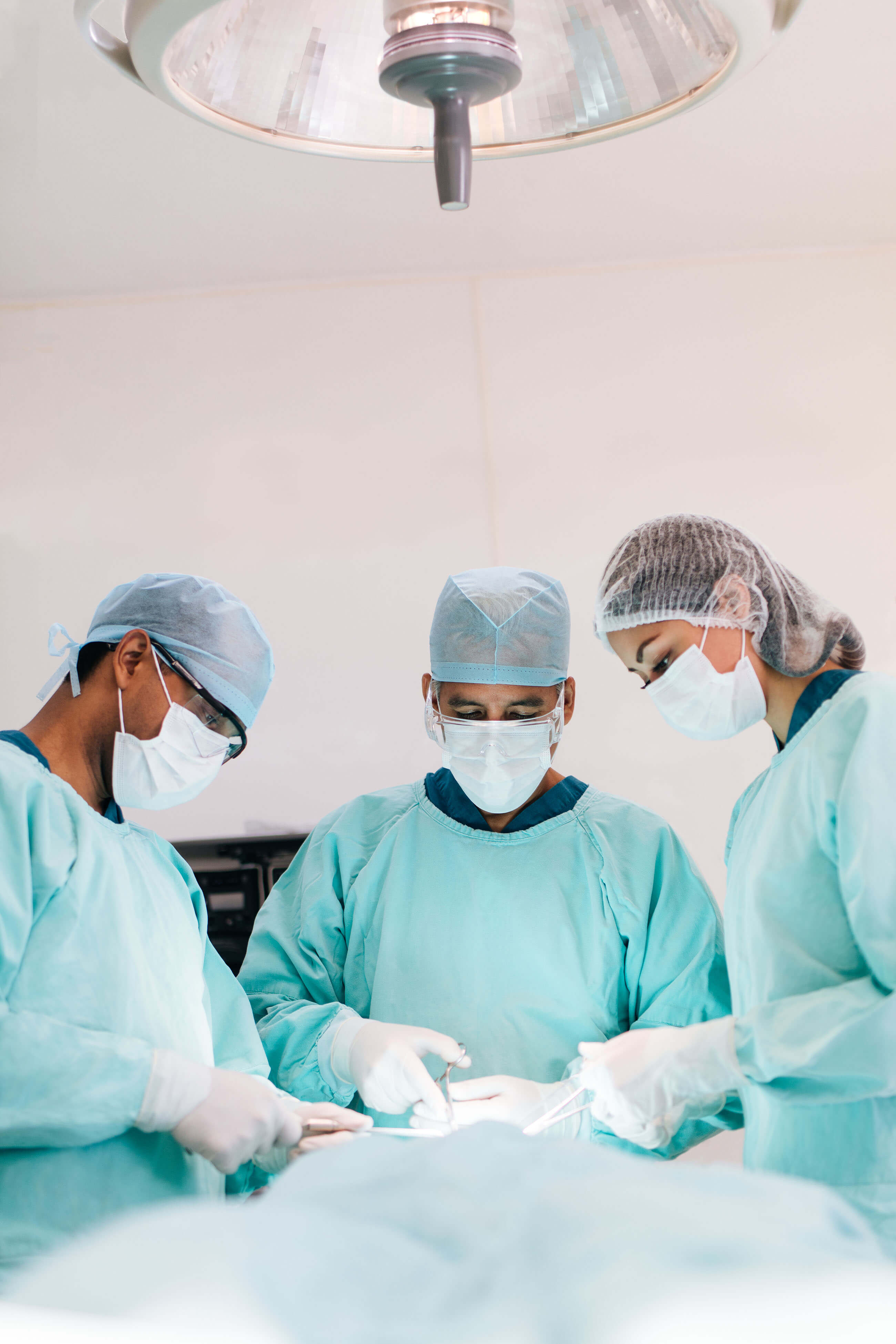 Three surgeons performing surgery